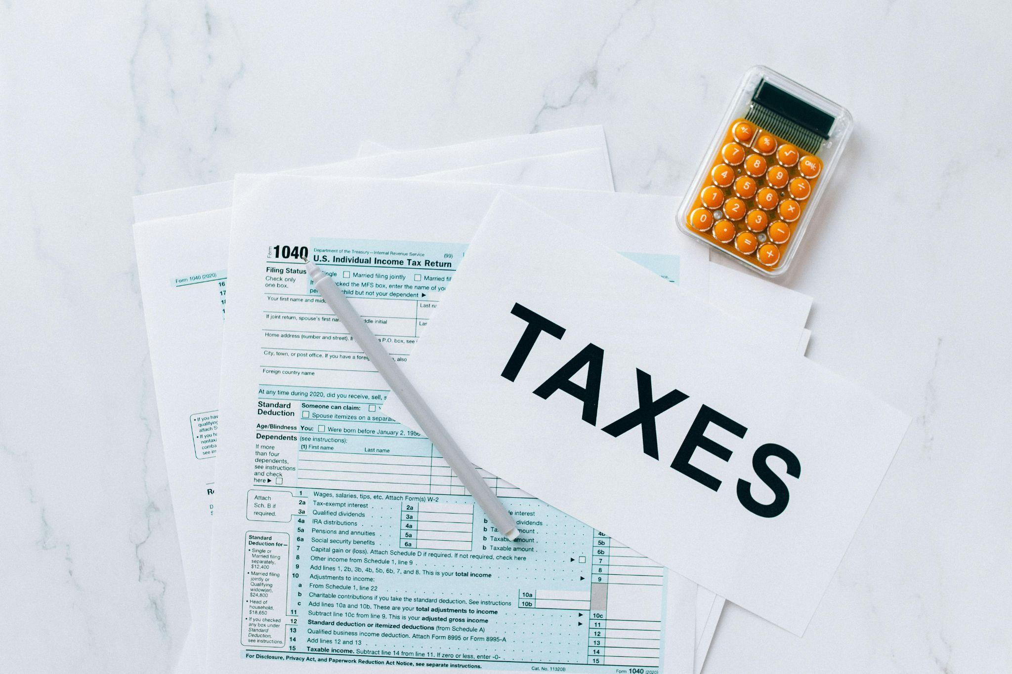 Tax document and calculator are placed on a desk